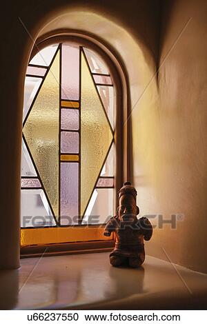 Stock Image - Close-up of an artifact with stained glass window in the background; Santa Fe; New Mexico; USA. Fotosearch