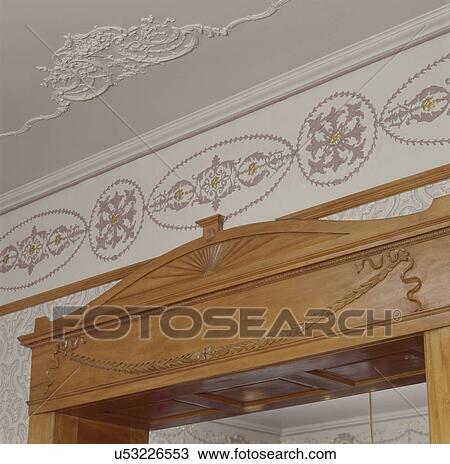 Close-up of intricately carving on maple door frame ceiling plaster embellishments View Large Photo Image Stock Image - Close-up of intricately carving on maple door frame ceiling plaster embellishments. Fotosearch