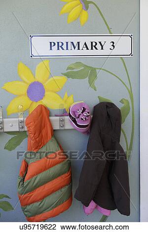 Stock Image - Close-up of jackets hung on wall at primary school; Tampa; Florida; USA. Fotosearch