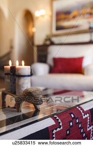 Close-up of lit candles on coffee table with upholstered armchair in living room; Santa Fe; New Mexico; USA View Large Photo Image Stock Photography - Close-up of lit candles on coffee table with upholstered armchair in living room; Santa Fe; New Mexico; USA. Fotosearch