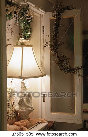Stock Photography - Close-up of lit table lamp in shelf; Oro Grande; California; USA. Fotosearch