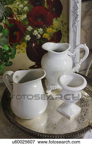 Stock Photo - Close-up of porcelain pitchers with silver tray; Oro Grande; California; USA; Route 66. Fotosearch