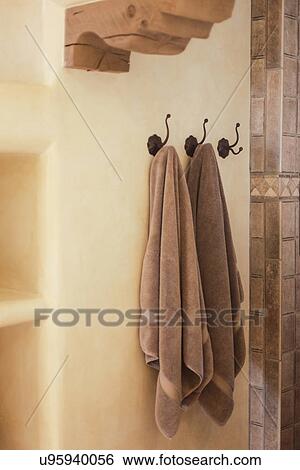 Stock Photograph - Close-up of two towels on hooks in the bathroom at home; Santa Fe; New Mexico; USA. Fotosearch