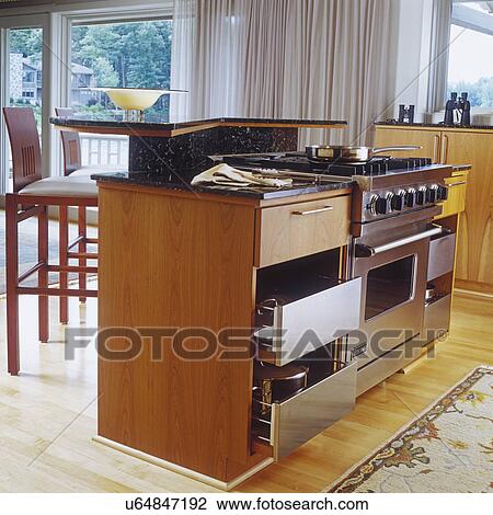 Contemporary style wood island includes stove; storage and seating View Large Photo Image Stock Image - Contemporary style wood island includes stove; storage and seating. Fotosearch