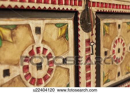 Stock Image - Detail shot of closed wooden cabinet with key; Santa Fe; New Mexico; USA. Fotosearch