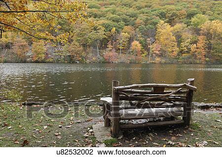 Empty bench facing lake at Bear Mountain park in the fall; New York; USA View Large Photo Image Stock Image - Empty bench facing lake at Bear Mountain park in the fall; New York; USA. Fotosearch