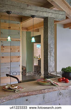 Stock Image - Food on kitchen counter below hanging lights at home; Burlington; Vermont; USA. Fotosearch