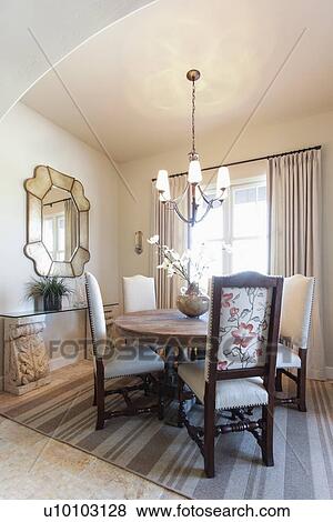 Stock Photo - Hanging light over dining table at home; Santa Fe; New Mexico; USA. Fotosearch
