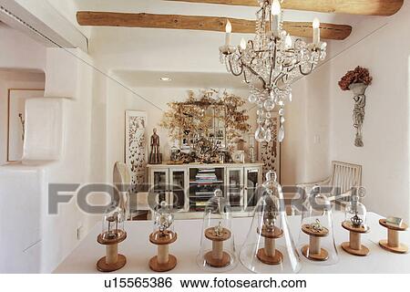 Stock Photograph - Hanging light over table with centerpieces; Santa Fe; New Mexico; USA. Fotosearch