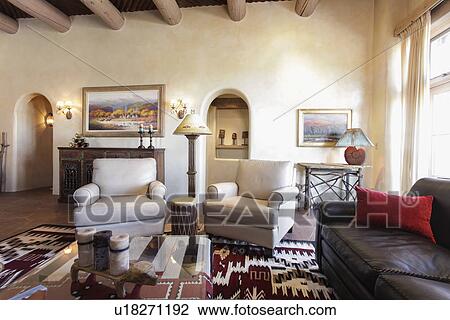 Stock Image - Living room with seating furniture and picture frames at home; Santa Fe; New Mexico; USA. Fotosearch