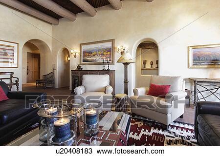 Stock Image - Living room with seating furniture and picture frames at home; Santa Fe; New Mexico; USA. Fotosearch