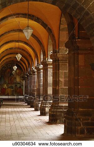 Picture - Main arched plaza walkway with hanging lights and pillars; San Miguel de Allende; Mexico. Fotosearch