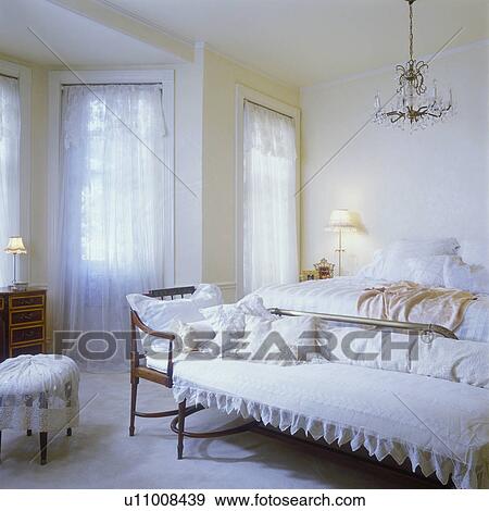 Messy Bedroom With Lace Curtains On Window At Home Stock Photo