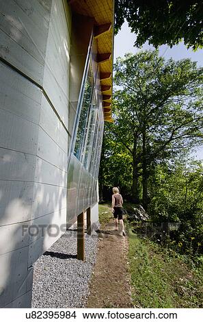 Rear view of a woman walking on dirt walkway along cropped stilt country house at USA View Large Photo Image Picture - Rear view of a woman walking on dirt walkway along cropped stilt country house at USA. Fotosearch