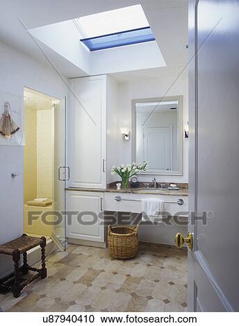 Sink and mirror with shower stall area and beige stone tile flooring View Large Photo Image Stock Image - Sink and mirror with shower stall area and beige stone tile flooring. Fotosearch