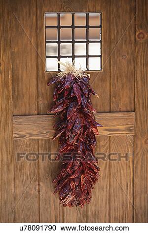 Traditional chilli ristra hangs from door; Santa Fe; New Mexico; USA View Large Photo Image Stock Image - Traditional chilli ristra hangs from door; Santa Fe; New Mexico; USA. Fotosearch