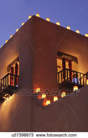 Stock Image - Traditional farolitos lit up on adobe structure; Santa Fe; New Mexico; USA. Fotosearch