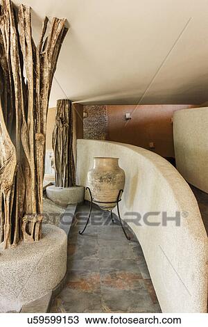 Urn with tree trunk along curved wall at beach resort in Zihuatenjo; Mexico View Large Photo Image Stock Image - Urn with tree trunk along curved wall at beach resort in Zihuatenjo; Mexico. Fotosearch