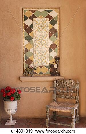 Stock Photo - View of a chair with vase and wall; Santa Fe; New Mexico; USA. Fotosearch