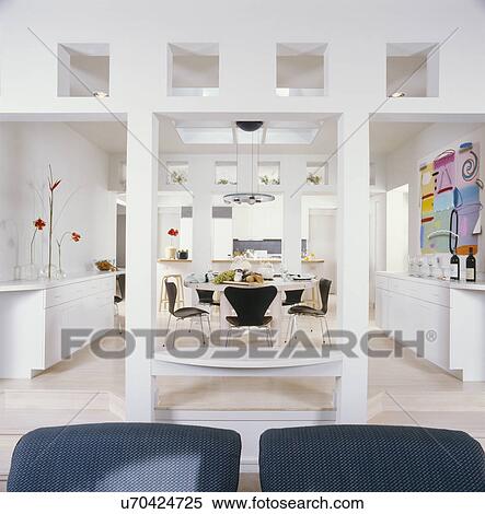View of dining area with kitchen in background at home View Large Photo Image Stock Photography - View of dining area with kitchen in background at home. Fotosearch