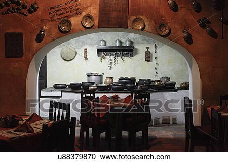 View of kitchen with seating arrangement in a restaurant at Antigua; Guatemala View Large Photo Image Stock Image - View of kitchen with seating arrangement in a restaurant at Antigua; Guatemala. Fotosearch
