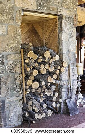 Stock Image - View of logs with stone wall; Chama; New Mexico; USA. Fotosearch