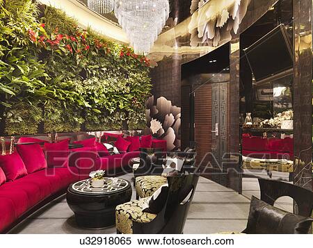 Walled red sofa with crystal chandeliers and plants in restaurant View Large Photo Image Stock Photography - Walled red sofa with crystal chandeliers and plants in restaurant. Fotosearch