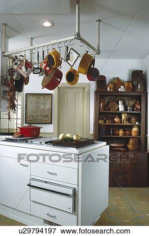 White Cabinets With Cupboard Filled With Collection Of Early