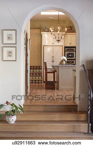Stock Image - Wooden stairs leading to the kitchen at home; Santa Fe; New Mexico; USA. Fotosearch