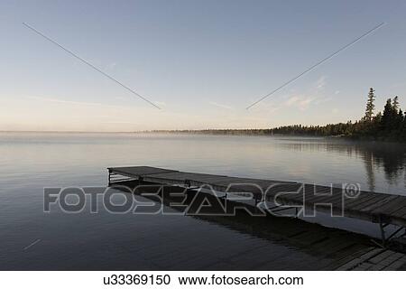 Stock Image - Boardwalk in a lake, Lake Audy Campground, Riding Mountain National Park, Manitoba, Canada. Fotosearch