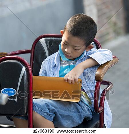 Boy using a digital tablet on cycle rickshaw, Hutong, Xicheng District, Beijing, China View Large Photo Image Stock Image - Boy using a digital tablet on cycle rickshaw, Hutong, Xicheng District, Beijing, China. Fotosearch