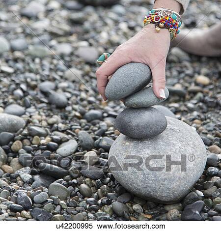 Close-up of a person's hand making stack of stones, Deception Pass State Park, Oak Harbor, Washington State, USA View Large Photo Image Stock Photography - Close-up of a person's hand making stack of stones, Deception Pass State Park, Oak Harbor, Washington State, USA. Fotosearch