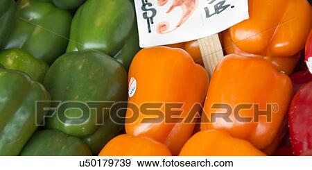 Stock Photo - Close-up of green and orange bell peppers for sale at a market stall, Pike Place Market, Seattle, Washington State, USA. Fotosearch