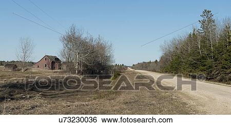 Stock Photograph - Dirt road passing through a field, Manitoba, Canada. Fotosearch
