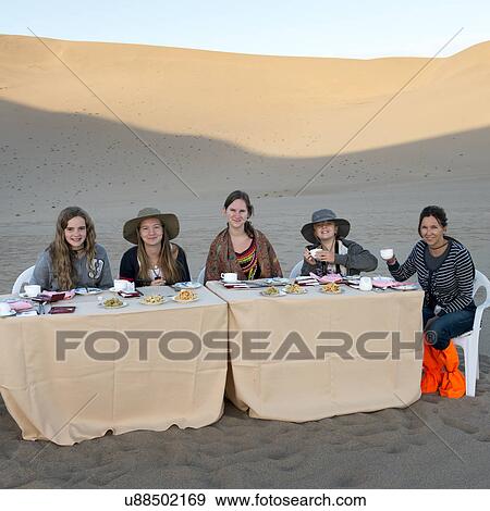 Family enjoying breakfast in desert at Mingsha Shan, Dunhuang, Jiuquan, Gansu Province, China View Large Photo Image Stock Photo - Family enjoying breakfast in desert at Mingsha Shan, Dunhuang, Jiuquan, Gansu Province, China. Fotosearch