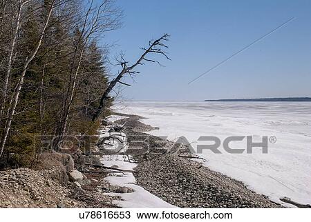 Stock Image - Frozen lake shoreline in winter, Lake Winnipeg, Hecla Grindstone Provincial Park, Manitoba, Canada. Fotosearch