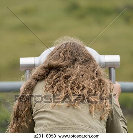 Stock Photo - Girl looking through a coin-operated binoculars, Western Brook Pond, Norris Point, Gros Morne National Park, Newfoundland And Labrador, Canada. Fotosearch