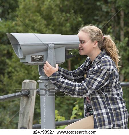 Girl looking through a coin-operated binoculars, Joey's Lookout, Gambo, Newfoundland And Labrador, Canada View Large Photo Image Stock Photo - Girl looking through a coin-operated binoculars, Joey's Lookout, Gambo, Newfoundland And Labrador, Canada. Fotosearch
