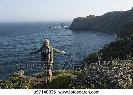 Girl with arm outstretched at Skerwink Trail, Port Rexton, Bonavista Peninsula, Newfoundland And Labrador, Canada View Large Photo Image Stock Photography - Girl with arm outstretched at Skerwink Trail, Port Rexton, Bonavista Peninsula, Newfoundland And Labrador, Canada. Fotosearch