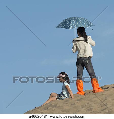 Girls on sand dune at Mingsha Shan, Dunhuang, Jiuquan, Gansu Province, China View Large Photo Image Stock Image - Girls on sand dune at Mingsha Shan, Dunhuang, Jiuquan, Gansu Province, China. Fotosearch