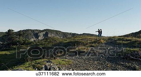 Stock Image - Hikers at Long Point Hiking Trail, Crow Head, Twillingate, North Twillingate Island, Newfoundland And Labrador, Canada. Fotosearch