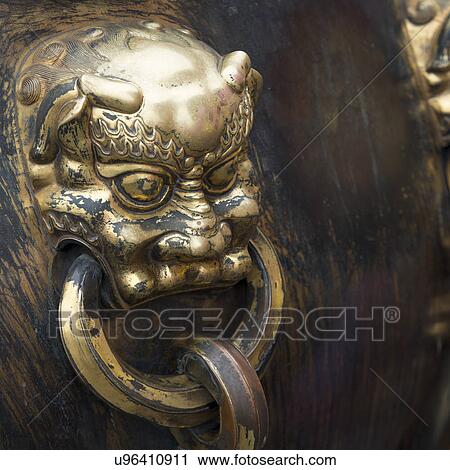 Stock Image - Lion handle on a bronze urn at the Forbidden City, Xicheng District, Beijing, China. Fotosearch