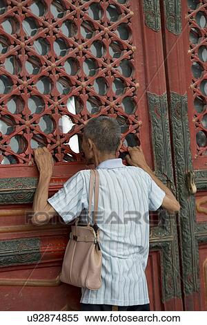 Man looking through window at Forbidden City, Xicheng District, Beijing, China View Large Photo Image Stock Photography - Man looking through window at Forbidden City, Xicheng District, Beijing, China. Fotosearch