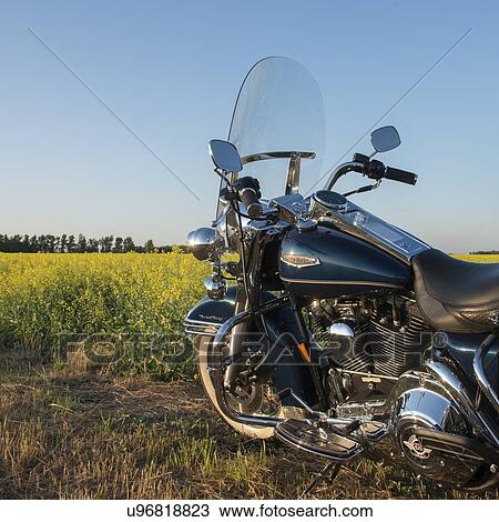 Stock Image - Motorcycle parked in a field, Oak Bluff, Manitoba, Canada. Fotosearch