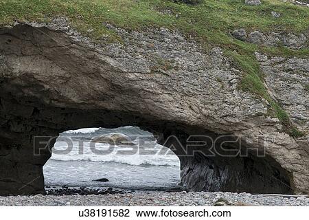 Stock Image - Natural arch at coast, Gros Morne National Park, Newfoundland And Labrador, Canada. Fotosearch