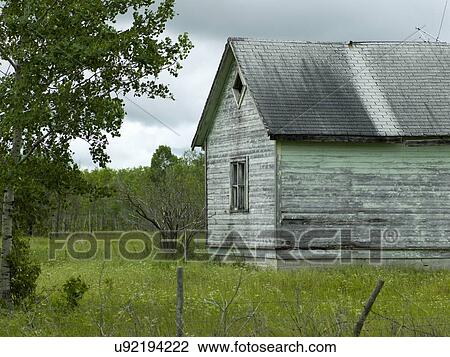 Stock Image - Old abandoned barn in a field, Komarno, Manitoba, Canada. Fotosearch
