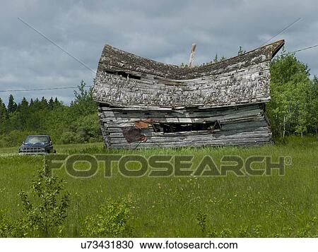 Stock Image - Old abandoned barn in a field, Manitoba, Canada. Fotosearch