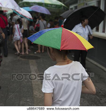 Stock Photo - People with umbrellas, Forbidden City, Xicheng District, Beijing, China. Fotosearch