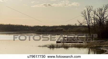 Stock Image - Pier in a lake, Manitoba, Canada. Fotosearch