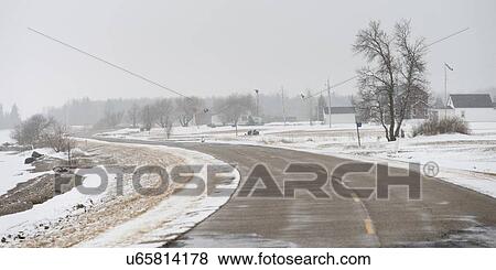 Stock Photo - Road passing through snow covered landscape, Riverton, Hecla Grindstone Provincial Park, Manitoba, Canada. Fotosearch